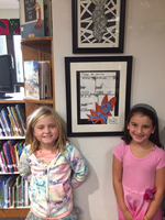 Cultural arts helpers hang student art work